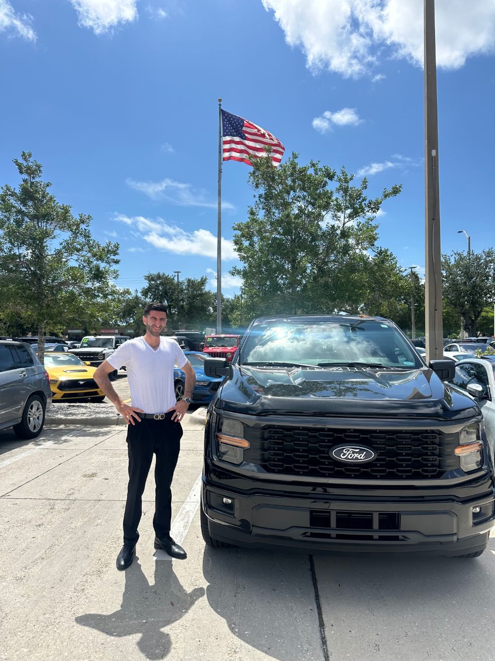 Joey Macellari with a freshly detailed black Ford F-150
